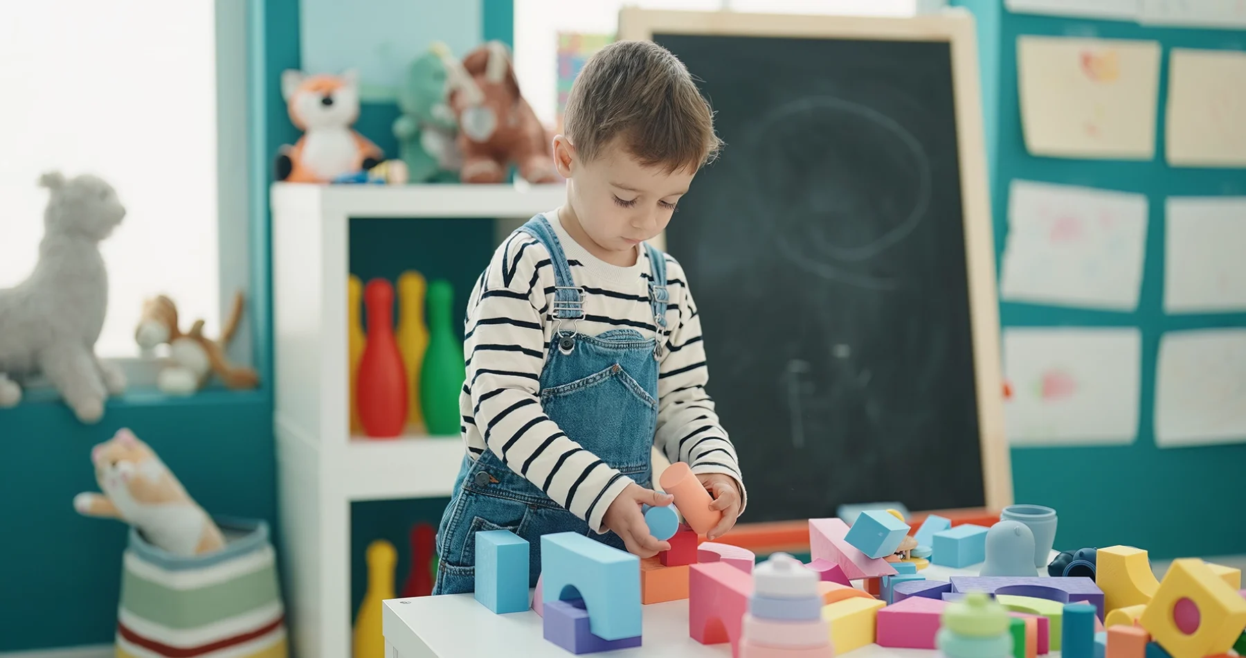 adorable-caucasian-boy-playing-with-construction-blocks-kindergarten copia